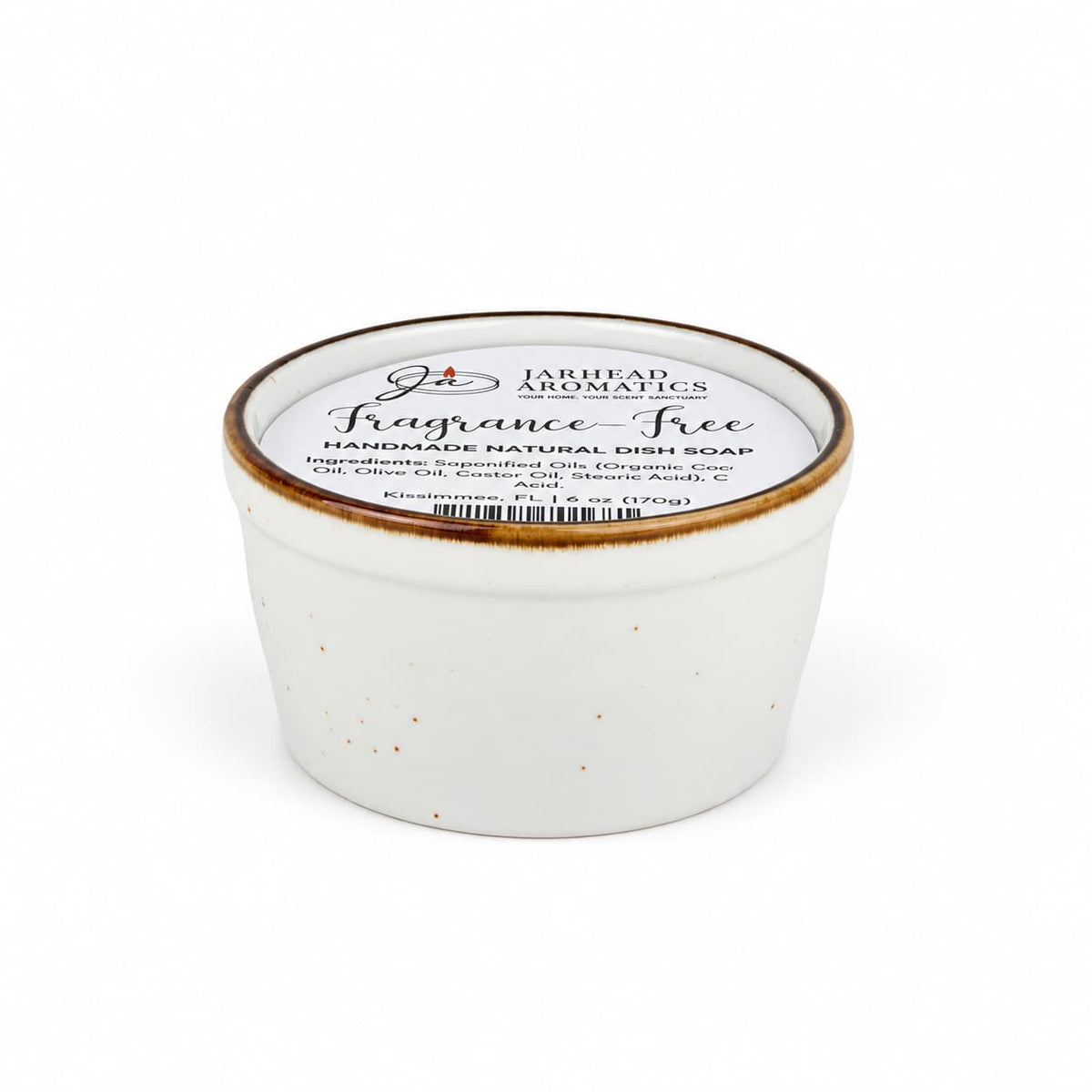 A white ceramic ramekin filled with a Fragrance-Free Handmade Natural Solid Dish Soap | Kitchen Cleaning Bar, featuring a label that lists the ingredients.