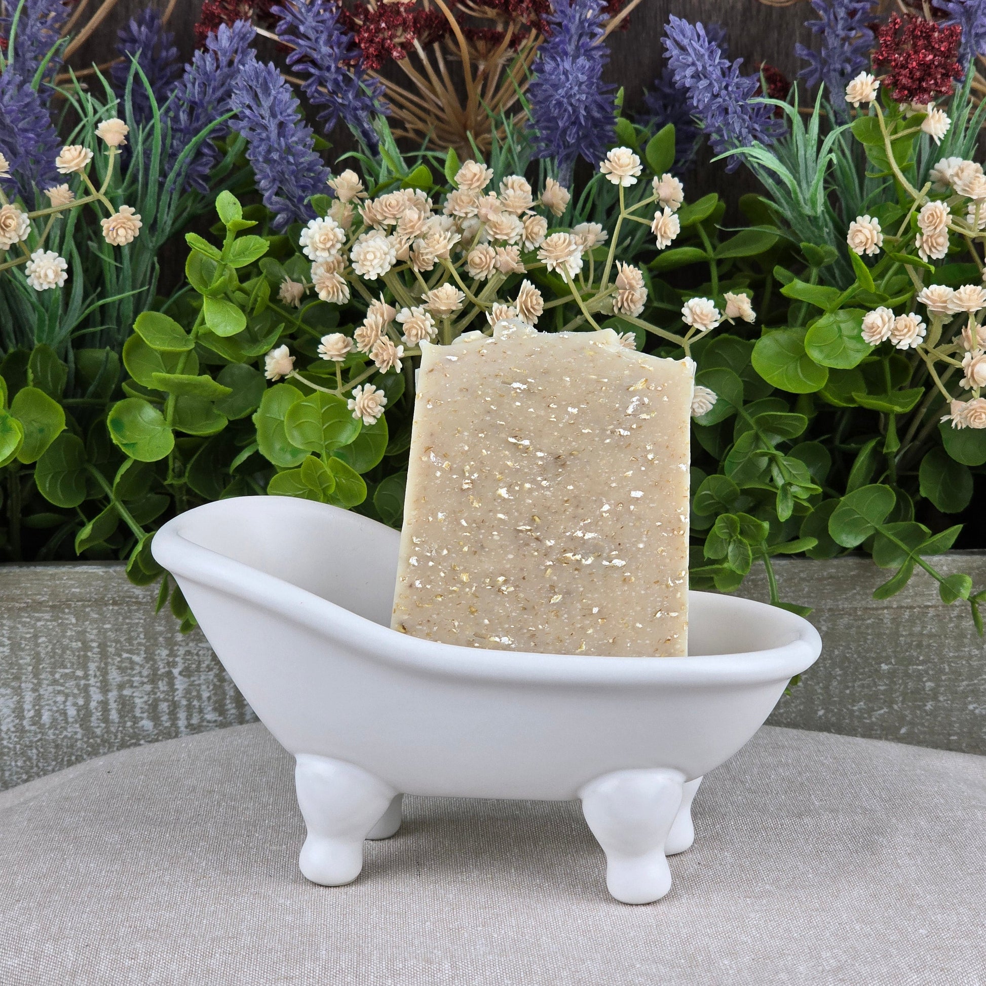 The Fragrance-Free Oatmeal Handmade Artisan Soap by Jarhead Aromatics rests in the bathtub, crafted for sensitive skin and made with all-natural ingredients.