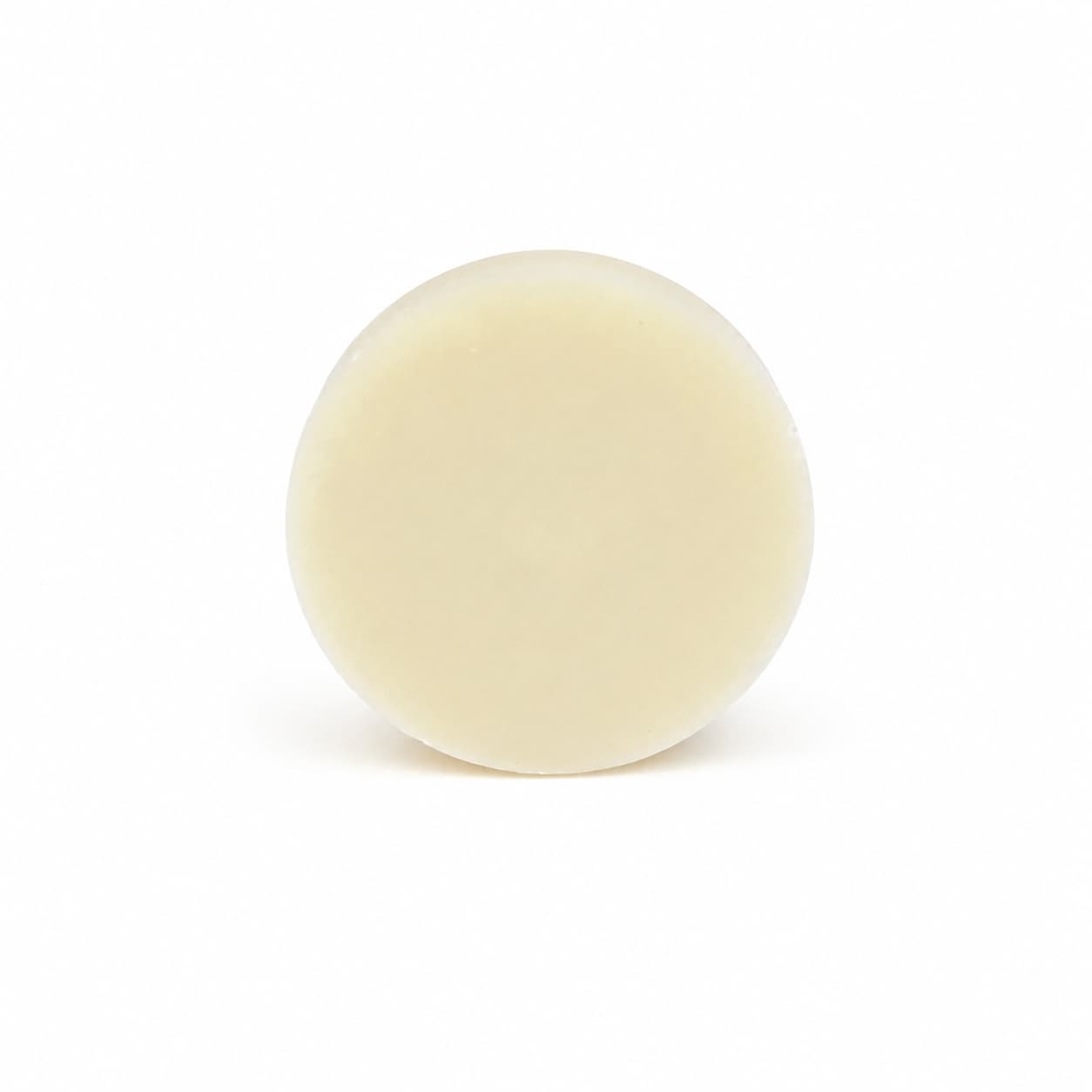A round, cream-colored solid bar of Lemon Handmade Natural Solid Dish Soap from Jarhead Aromatics—featuring invigorating lemon essential oil—is centered against a plain white background.