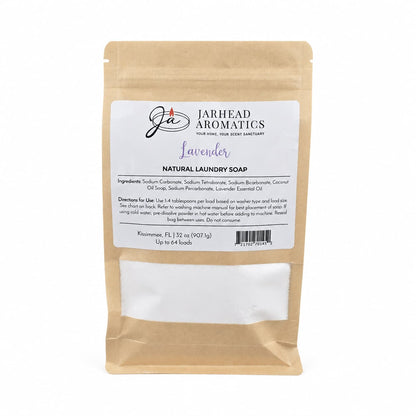 A 32 oz brown resealable bag of Jarhead Aromatics Lavender Handmade Natural Laundry Soap—a powdered detergent with lavender essential oil—features product details and directions on the front label for effective, gentle cleaning. The design includes white space at the bottom for a batch or weight sticker.