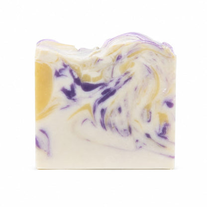 A rectangular bar of Jarhead Aromatics’ Lavender + Lemon Handmade Coconut Milk Artisan Soap—featuring a marbled pattern in white, yellow, and purple tones evocative of calming lavender and bright lemon—is displayed against a plain white background.