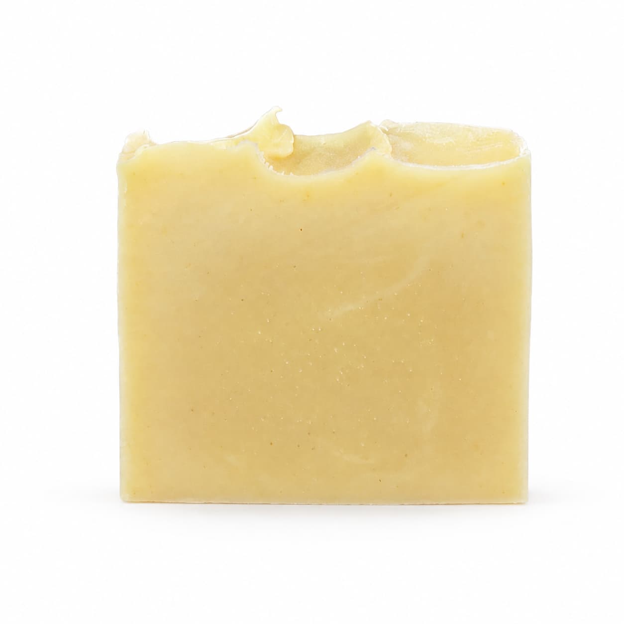 A rectangular, yellow-toned bar of Jarhead Aromatics Lavender + Peppermint Handmade Natural Artisan Soap, featuring a slightly uneven top edge, is set against a plain white background.