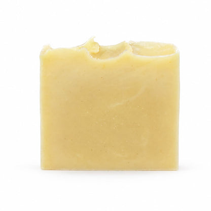 A rectangular, yellow-toned bar of Jarhead Aromatics Lavender + Peppermint Handmade Natural Artisan Soap, featuring a slightly uneven top edge, is set against a plain white background.