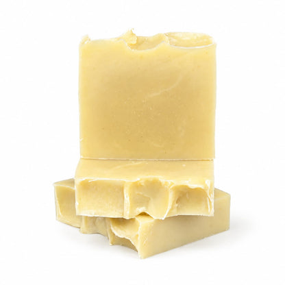 Two rectangular bars of Lavender + Peppermint Handmade Natural Artisan Soap by Jarhead Aromatics, featuring a pale yellow hue with rough, uneven edges and a smooth surface, stacked on top of each other against a plain white background.