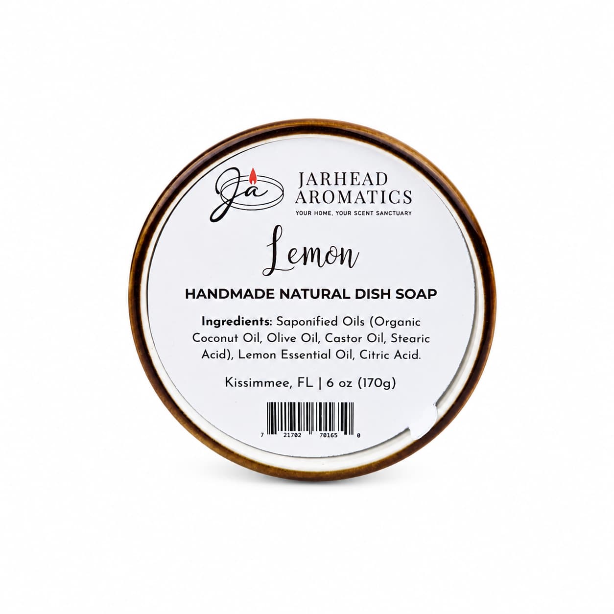 A round container labeled "Jarhead Aromatics Lemon Handmade Natural Solid Dish Soap | Citrus Kitchen Cleaning Bar with Lemon Essential Oil," listing ingredients and weight, sits against a white background. This plant-based dish soap bar offers a refreshing lemon aroma and a solid formula for an eco-friendly kitchen clean.