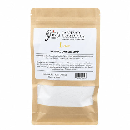 A brown resealable bag of Jarhead Aromatics Lemon Handmade Natural Laundry Soap | Powdered Detergent with Lemon Essential Oil, featuring a white label with ingredient list and directions, and visible white handmade detergent powder inside the clear window at the bottom.