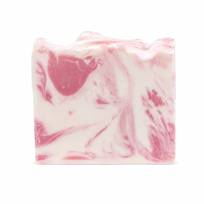 A rectangular bar of Jarhead Aromatics Magnolia + Lavender Handmade Coconut Milk Artisan Soap, featuring a white base with pink swirled patterns, rests on a plain white background.