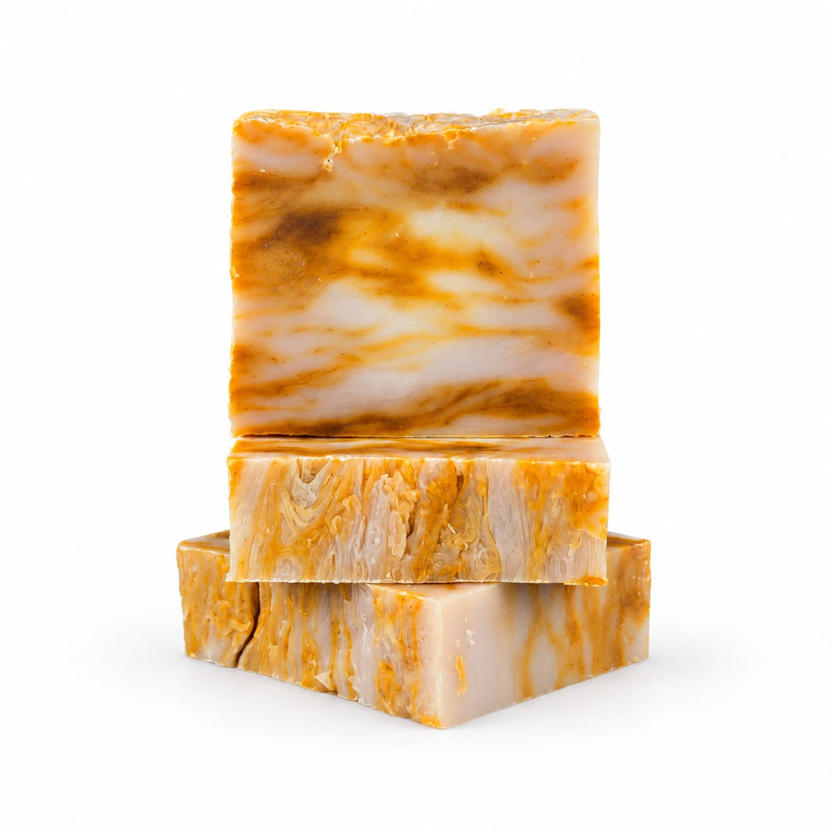 Three rectangular bars of Jarhead Aromatics Mango + Guava Natural Handmade Soap, featuring a swirled orange and white design, stacked on top of each other.
