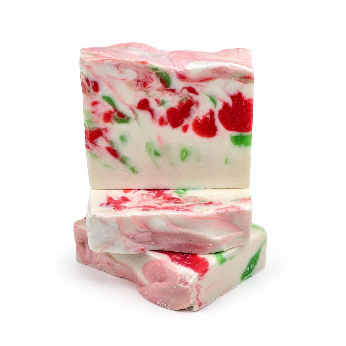Three stacked bars of Mistletoe Handmade Artisan Soap featuring a marbled white, red, and green pattern.