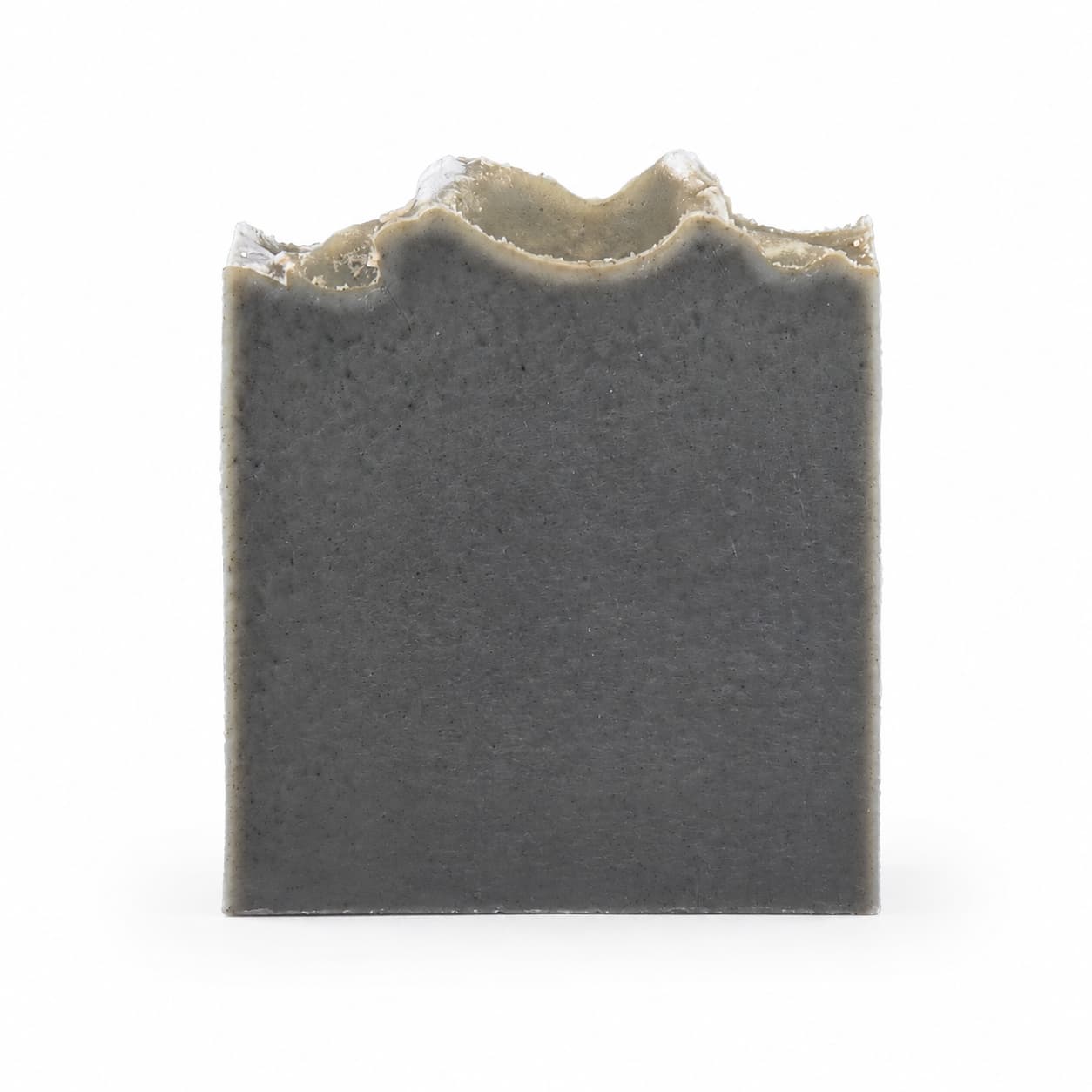 A rectangular, charcoal-gray bar of Mugwort + Lavender Handmade Natural Artisan Soap from Jarhead Aromatics, featuring a rough, uneven top edge, is shown against a plain white background.