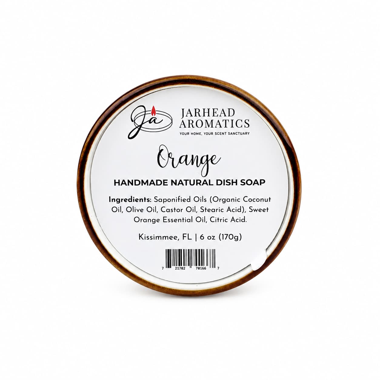 A round tin labeled "Jarhead Aromatics Orange Handmade Natural Solid Dish Soap | Citrus Kitchen Cleaning Bar with Essential Oils" displays its ingredients and a weight of 6 oz (170g) against a white background with black text, showcasing this plant-based cleaning bar as a natural solid dish soap.