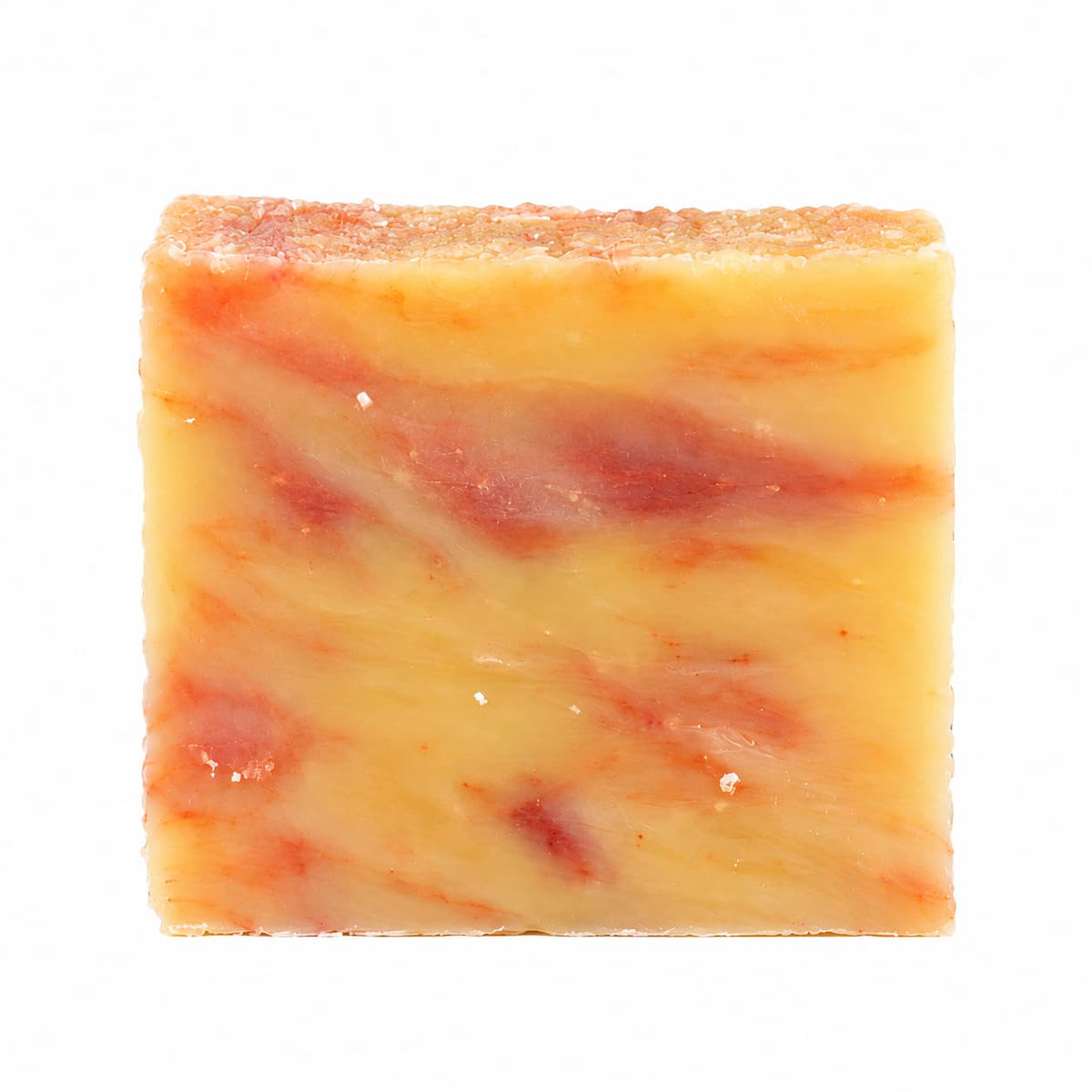 Square bar of Orange + Lime Natural Handmade Soap by Jarhead Aromatics with orange and yellow swirls and a textured top.