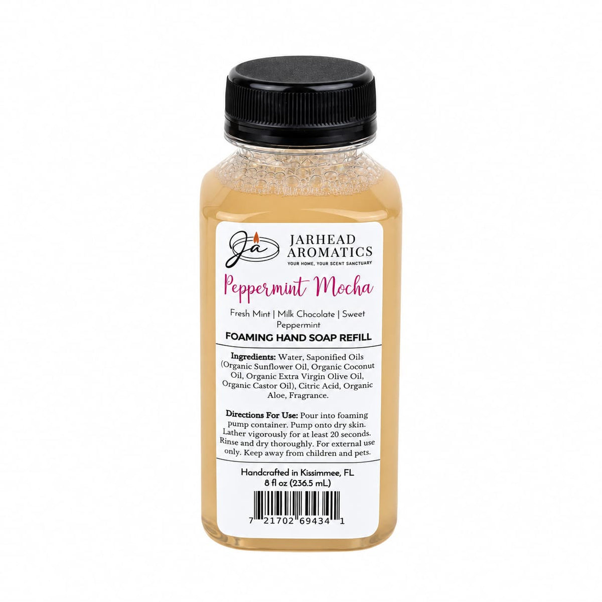 A bottle of Jarhead Aromatics Peppermint Mocha Handmade Foaming Hand Soap refill with a label listing ingredients, directions, and holiday scent notes of fresh mint, milk chocolate, and sweet peppermint.