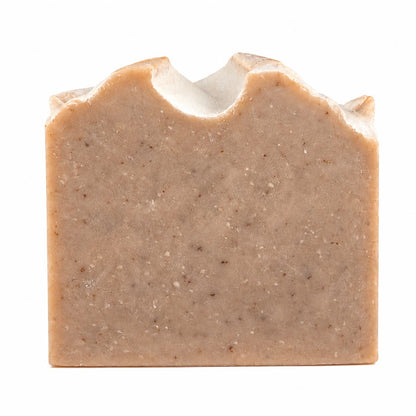 A rectangular, handcrafted bar of Jarhead Aromatics Pumpkin + Spice Handmade Artisan Soap, featuring a textured top edge and visible specks throughout, is set against a white background.