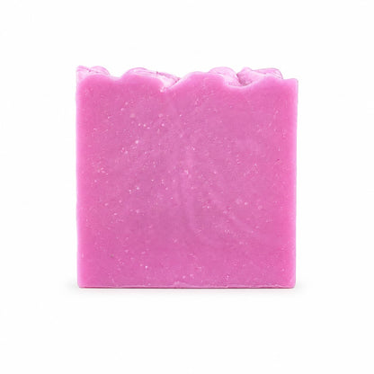A rectangular bar of Rose + Hibiscus Handmade Coconut Milk Artisan Soap by Jarhead Aromatics, featuring a slightly wavy top edge and displayed against a plain white background.