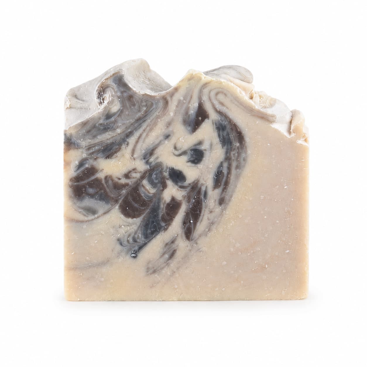 A bar of Sandalwood + Patchouli Handmade Artisan Soap by Jarhead Aromatics, featuring a beige base and dark brown, swirling marbled patterns on the top and front, displayed against a plain white background.