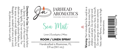 White rectangular label for Jarhead Aromatics Sea Mist Room & Linen Spray, Sea Salt & Spa-Inspired scent. Includes product name, scent notes, usage directions, warning, company logo, barcode, and size—ideal for coastal home fragrance.
