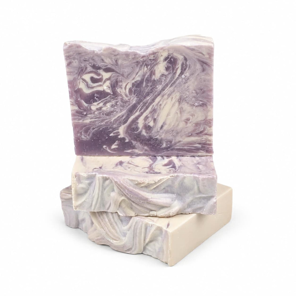 Three rectangular bars of Sugar Plum Handmade Coconut Milk Artisan Soap stacked on top of each other, featuring swirls of purple and cream.