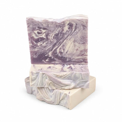 Three rectangular bars of Sugar Plum Handmade Coconut Milk Artisan Soap stacked on top of each other, featuring swirls of purple and cream.