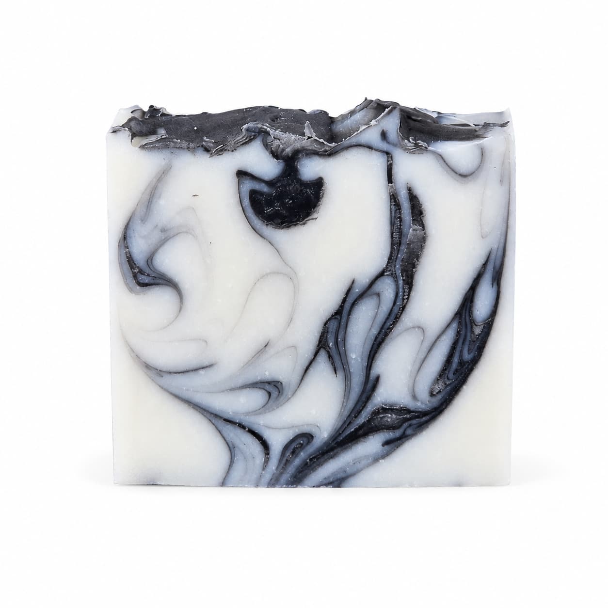 A rectangular bar of Jarhead Aromatics Tea Tree + Charcoal Handmade Natural Tallow Artisan Soap, featuring intricate black and gray swirling patterns and a textured, uneven top edge, set against a plain white background.