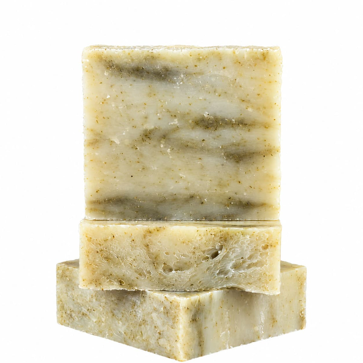 Three rectangular bars of Jarhead Aromatics Tea Tree Natural Handmade Soap, which are speckled and light green, stacked on top of one another.
