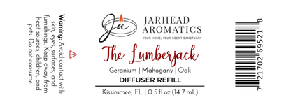 White product label for Jarhead Aromatics The Lumberjack Cold Air Diffuser Refill | Mahogany & Cedarwood, featuring a rich blend of mahogany, cedarwood, and geranium. Warning: avoid eye contact; keep from children and pets. Size: 0.5 fl oz.