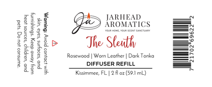Label for Jarhead Aromatics The Sleuth Diffuser Refill | Rosewood, Leather & Sandalwood Mystery Home Fragrance Oil. Avoid contact with skin/surfaces. Net 2 fl oz (59.1 mL). Made in Kissimmee, FL. Barcode on right.