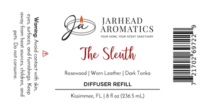 Jarhead Aromatics The Sleuth Diffuser Refill offers a masculine blend of rosewood, leather, and sandalwood. Warning: avoid skin/eye contact. Size: 8 fl oz (236.5 mL). Includes barcode; location: Kissimmee, FL.