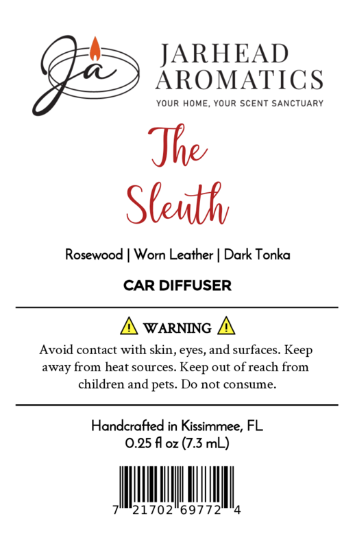 Label for Jarhead Aromatics "The Sleuth" Car Diffuser—warm leather, cedar & sandalwood scent. Includes heat and skin contact warnings plus barcode at bottom.