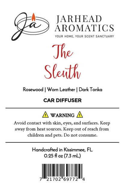 Label for Jarhead Aromatics "The Sleuth" Car Diffuser—warm leather, cedar & sandalwood scent. Includes heat and skin contact warnings plus barcode at bottom.
