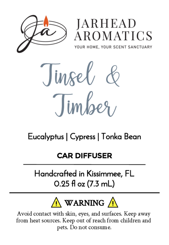 Jarhead Aromatics Tinsel & Timber car diffuser features eucalyptus, cypress, and tonka bean aromas reminiscent of holiday greenery. Handcrafted with essential oils in Kissimmee, FL. Contact and usage warnings included.