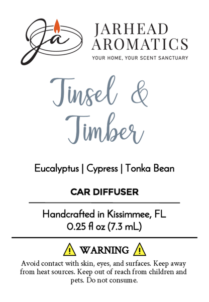Jarhead Aromatics Tinsel & Timber car diffuser features eucalyptus, cypress, and tonka bean aromas reminiscent of holiday greenery. Handcrafted with essential oils in Kissimmee, FL. Contact and usage warnings included.