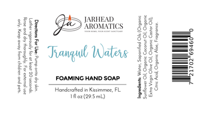 Jarhead Aromatics Tranquil Waters Foaming Hand Soap label: plant-based cleanser with organic oils, directions, ingredients, barcode, decorative text; white background with teal and black fonts; stylized JA logo at top.