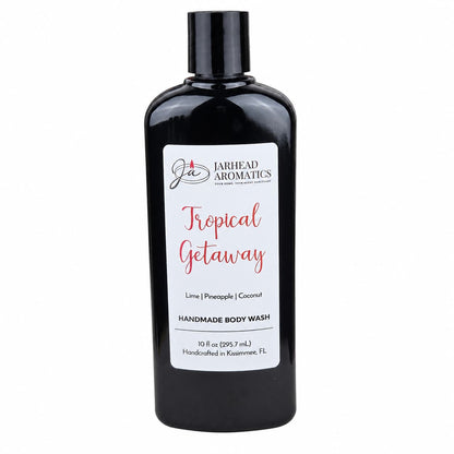 A 10 fl oz black bottle of Jarhead Aromatics Tropical Getaway Handmade Body Wash, featuring lime, pineapple, and coconut scents. This organic body wash is handcrafted in Kissimmee, FL and made with moisturizing organic aloe and plant-based oils.
