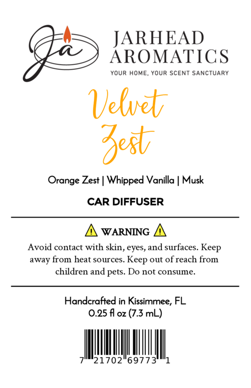 Label for Velvet Zest Car Diffuser | Citrus Vanilla & Brown Sugar Car Air Freshener by Jarhead Aromatics, a long-lasting scent with citrus, vanilla, and brown sugar. Includes warnings, manufacturing info, barcode, and candle flame logo.