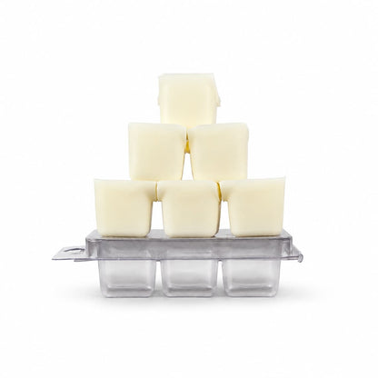 Six cubes of butter are stacked in a pyramid atop a silver ice cube tray with three empty compartments, all set against a plain white background—a geometric display that echoes the alluring design of Jarhead Aromatics’ Bewitching Hour Soy Wax Melt | Exotic Spices, Dark Florals & Smoky Woods, celebrated for its bewitching fragrance and visual sophistication.