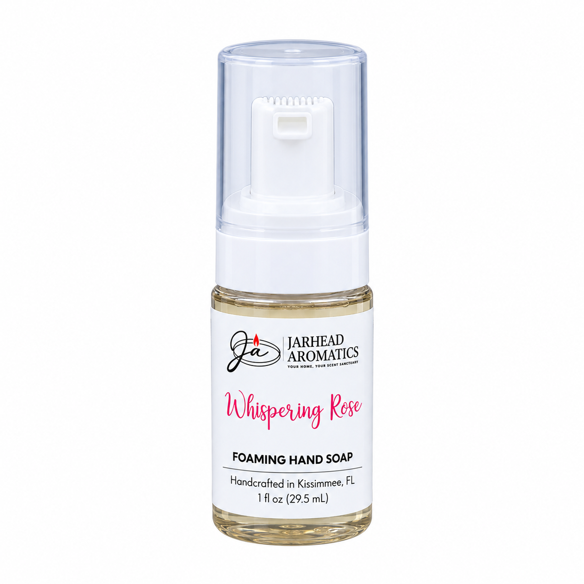 A small, clear plastic bottle of Jarhead Aromatics Whispering Rose Handmade Foaming Hand Soap with a white pump dispenser and a label that reads Whispering Rose Foaming Hand Soap.
