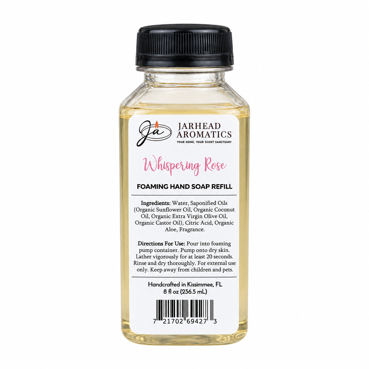A clear plastic bottle of Jarhead Aromatics Whispering Rose Handmade Foaming Hand Soap refill with a black cap and a white label featuring product ingredients, usage instructions, and a barcode.