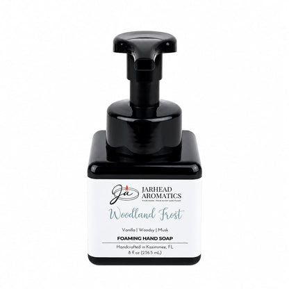 A square black bottle of Jarhead Aromatics Woodland Frost Handmade Foaming Hand Soap, featuring a black pump dispenser and a white label.