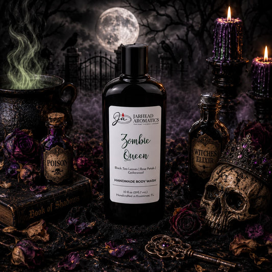 A bottle of Zombie Queen Handmade Body Wash by Jarhead Aromatics, scented with black tea, rose petals, and cedarwood, sits among a skull, crown, poison bottles, a Book of Shadows, wilted roses, and a dark, foggy graveyard under a full moon.