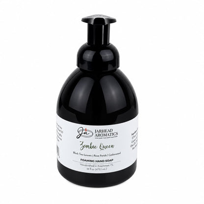A pump bottle of black foaming Zombie Queen Handmade Foaming Hand Soap, featuring a label listing black tea, rose petals, and cedarwood.