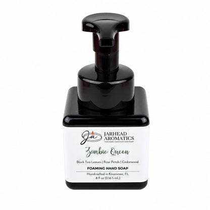 Square black bottle of Zombie Queen Handmade Foaming Hand Soap with a pump dispenser and a label featuring the scent profile of black tea, rose petals, and cedarwood.